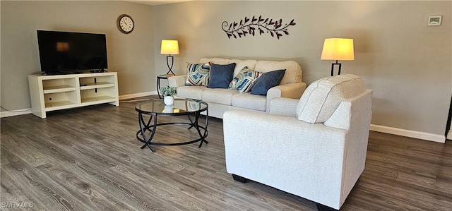 living area featuring wood finished floors and baseboards