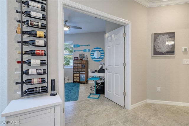 hallway with ornamental molding and light tile patterned floors