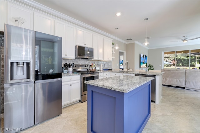 kitchen featuring stainless steel appliances, backsplash, pendant lighting, white cabinets, and kitchen peninsula