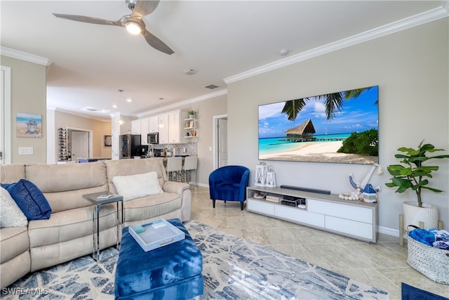 tiled living room with ceiling fan and crown molding