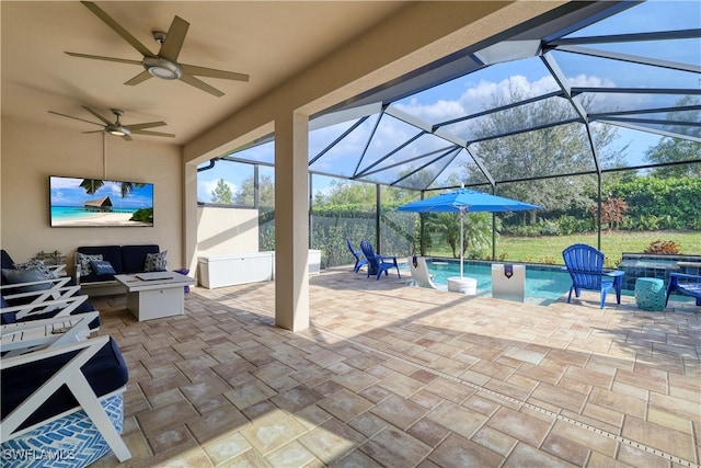 view of patio with ceiling fan and glass enclosure