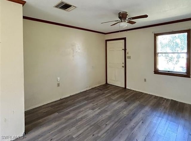 spare room featuring ornamental molding, dark hardwood / wood-style floors, and ceiling fan