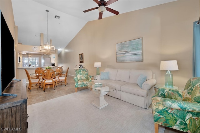 carpeted living room with high vaulted ceiling and ceiling fan