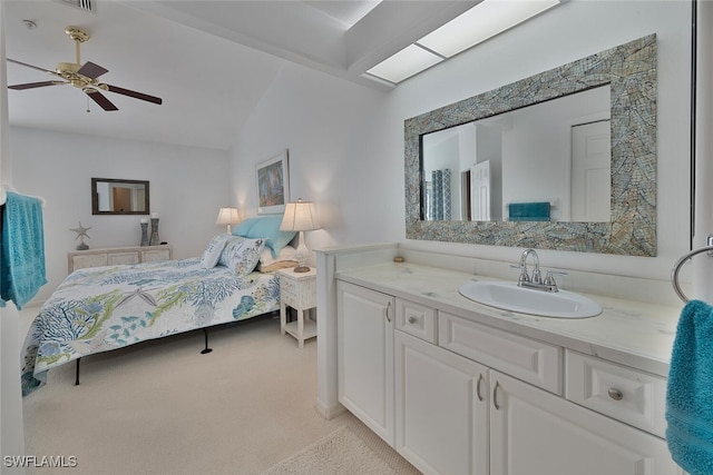 bedroom featuring ceiling fan, lofted ceiling, sink, and light colored carpet