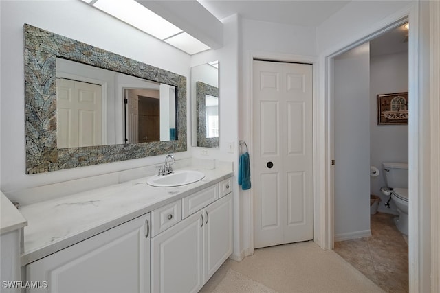13010 Amberley Ct Unit 208, Bonita Springs, FL 34135 - bathroom featuring vanity, toilet, tile patterned flooring, and baseboards
