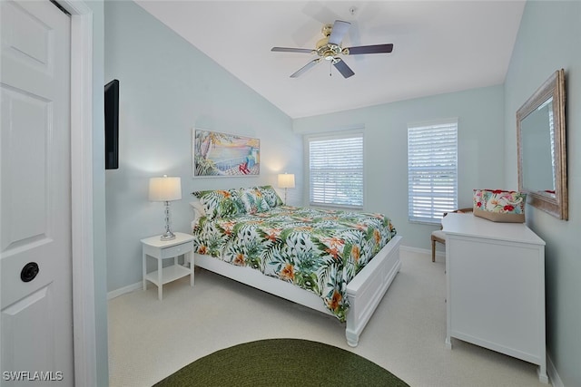 bedroom with ceiling fan, vaulted ceiling, and light colored carpet