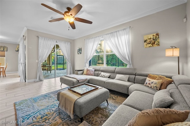 living room with a healthy amount of sunlight, crown molding, ceiling fan, and light hardwood / wood-style floors