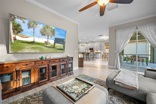 living room featuring ceiling fan, light hardwood / wood-style flooring, and ornamental molding