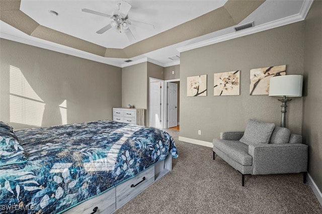 bedroom featuring a tray ceiling, ceiling fan, carpet, and ornamental molding