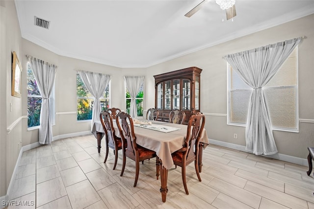 dining area featuring ceiling fan and ornamental molding