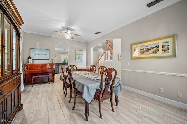 dining space featuring light hardwood / wood-style flooring, ceiling fan, and crown molding