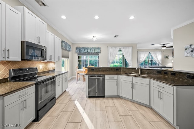 kitchen featuring white cabinets, dark stone countertops, sink, and stainless steel appliances