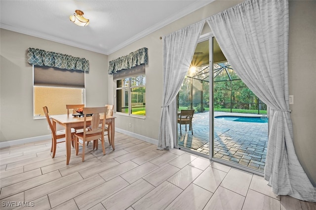 dining area with light hardwood / wood-style floors and ornamental molding