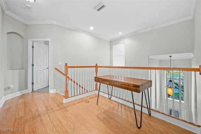 hallway featuring light hardwood / wood-style floors and crown molding