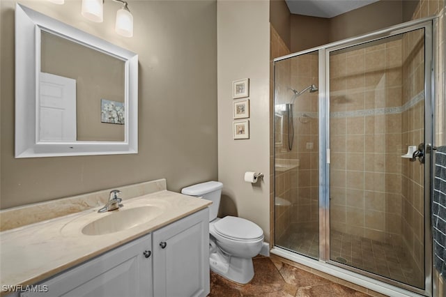 bathroom with vanity, toilet, and an enclosed shower