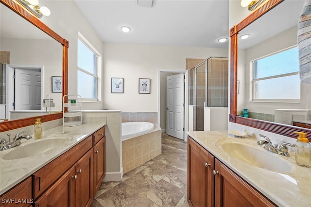 bathroom with shower with separate bathtub and vanity