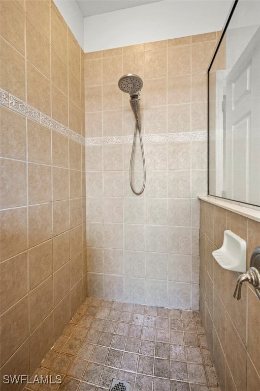 bathroom with a tile shower