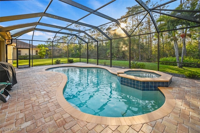 view of swimming pool with glass enclosure, an in ground hot tub, and a patio area