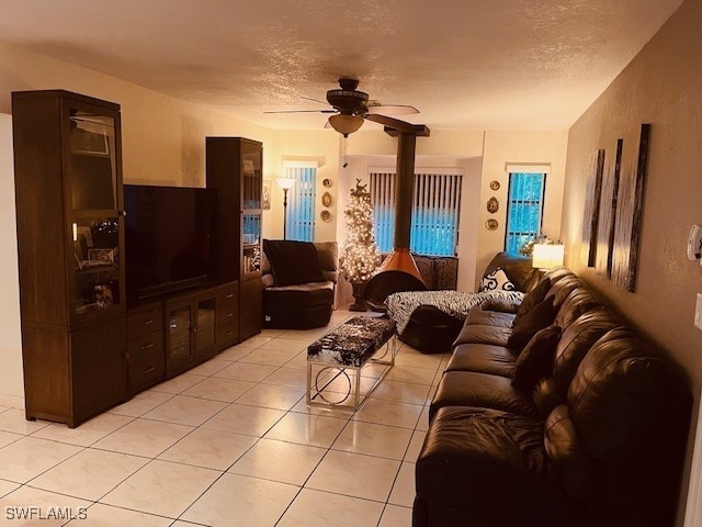 tiled living room with a textured ceiling and ceiling fan