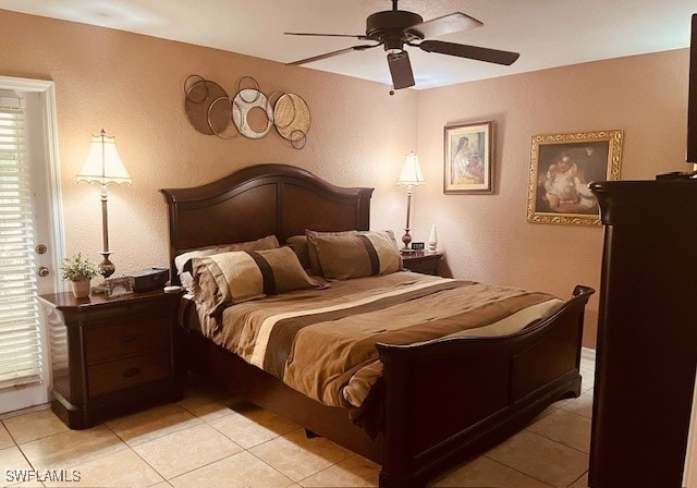 tiled bedroom featuring ceiling fan