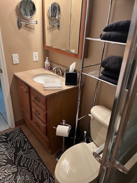 bathroom featuring toilet, vanity, and tile patterned floors