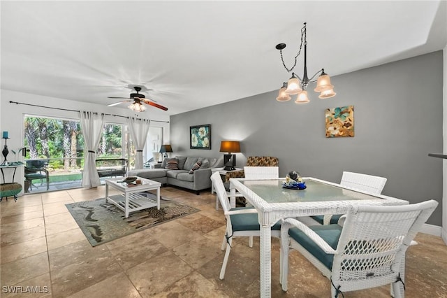 dining space with ceiling fan with notable chandelier