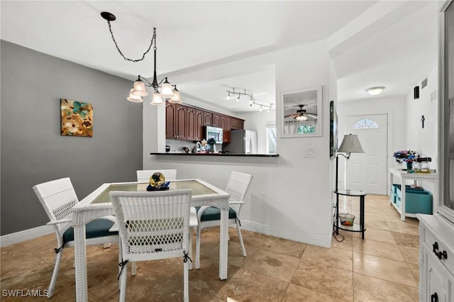 dining area with an inviting chandelier