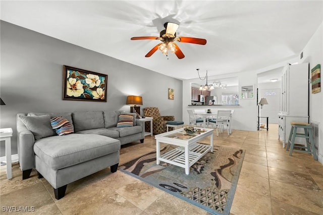 living room featuring ceiling fan with notable chandelier