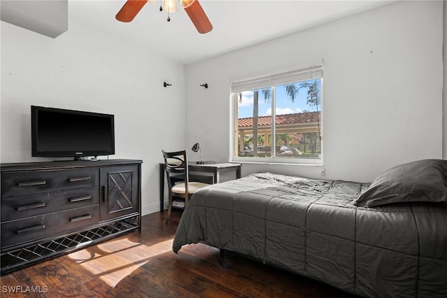 bedroom with ceiling fan and dark hardwood / wood-style flooring