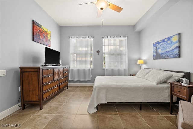 tiled bedroom featuring ceiling fan