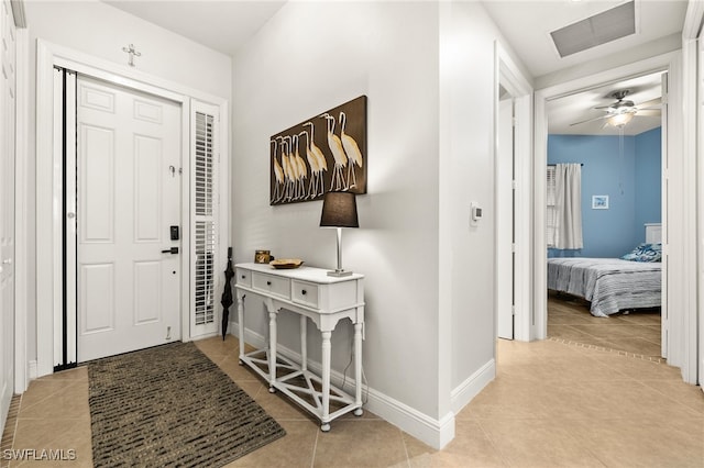 entryway featuring light tile patterned flooring and ceiling fan