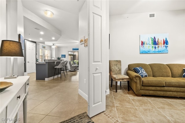 tiled living room with ceiling fan