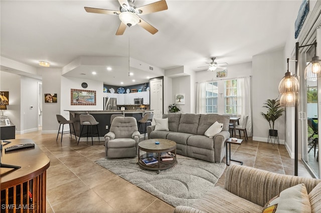 tiled living room with ceiling fan