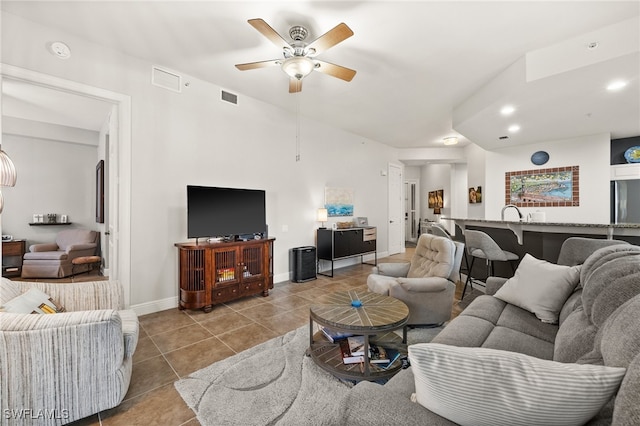 living room featuring ceiling fan and light tile patterned floors