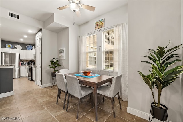 tiled dining room featuring ceiling fan