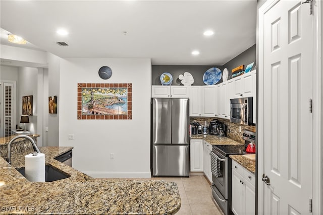 kitchen featuring white cabinetry, light stone countertops, and stainless steel appliances