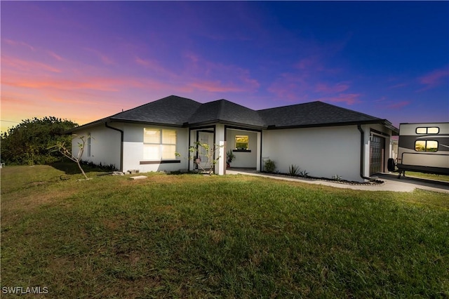 2918 12th St SW, Lehigh Acres, FL 33976 - view of front of house featuring stucco siding, a garage, a front lawn, and a shingled roof