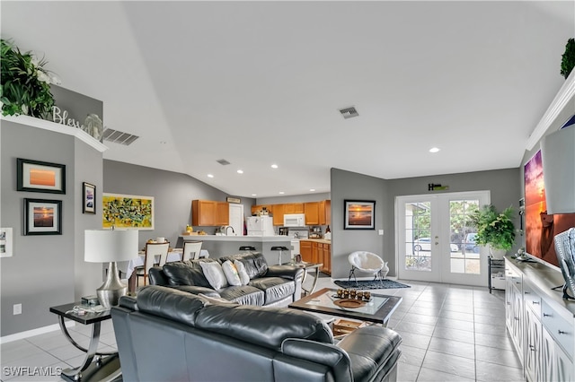 living room with french doors, vaulted ceiling, and light tile patterned floors