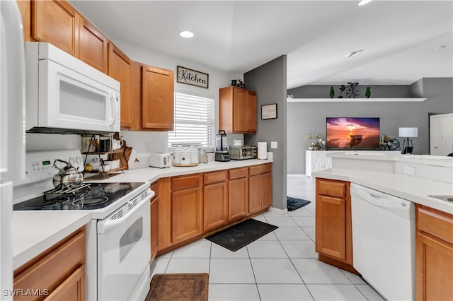 kitchen with light tile patterned flooring, vaulted ceiling, and white appliances