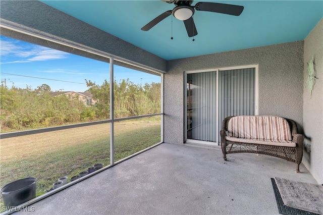 sunroom featuring ceiling fan