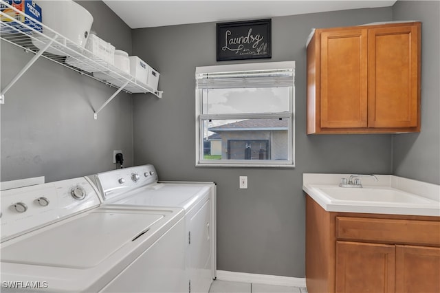 washroom with cabinets, sink, and washing machine and dryer