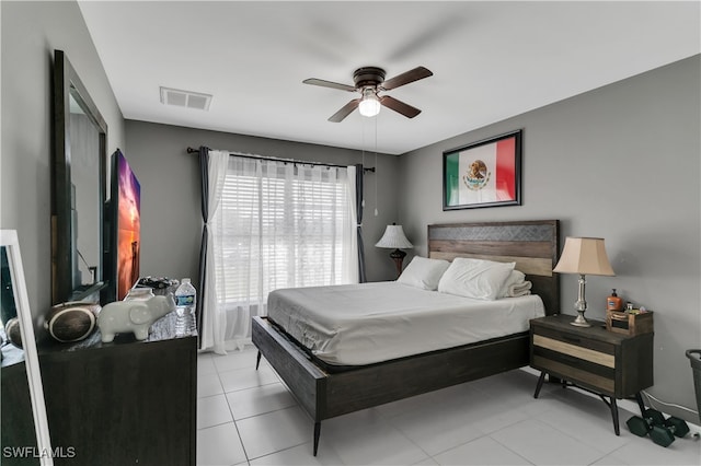 tiled bedroom featuring ceiling fan