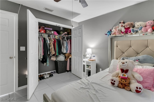 bedroom featuring a closet, light tile patterned flooring, and ceiling fan