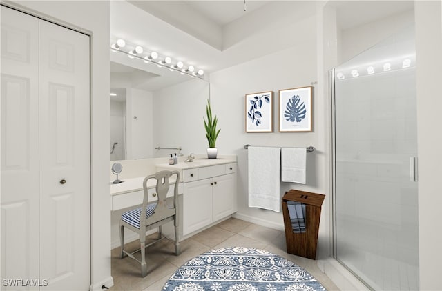 bathroom featuring vanity, a shower with door, and tile patterned flooring