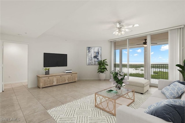 1001 Arbor Lake Dr Unit 1003, Naples, FL 34110 - living area featuring healthy amount of natural light, a ceiling fan, tile patterned flooring, and baseboards