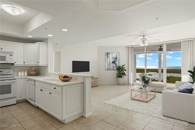 1001 Arbor Lake Dr Unit 1003, Naples, FL 34110 - kitchen featuring white appliances, open floor plan, light tile patterned flooring, recessed lighting, and a peninsula