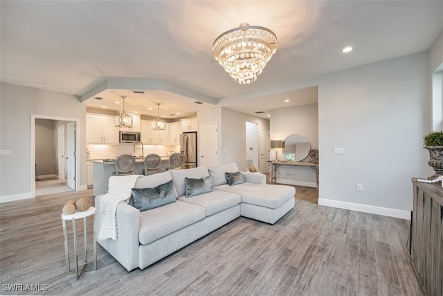 living room featuring sink and light wood-type flooring