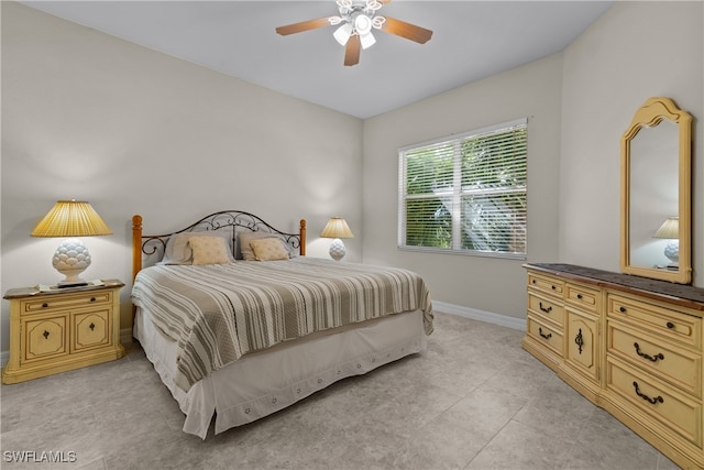 tiled bedroom featuring ceiling fan