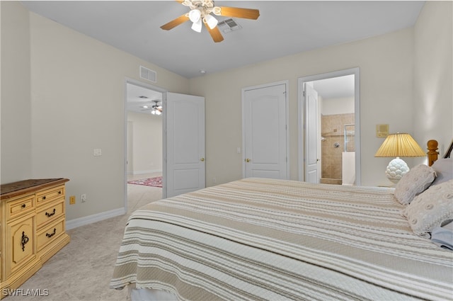 bedroom with ceiling fan, light carpet, and connected bathroom