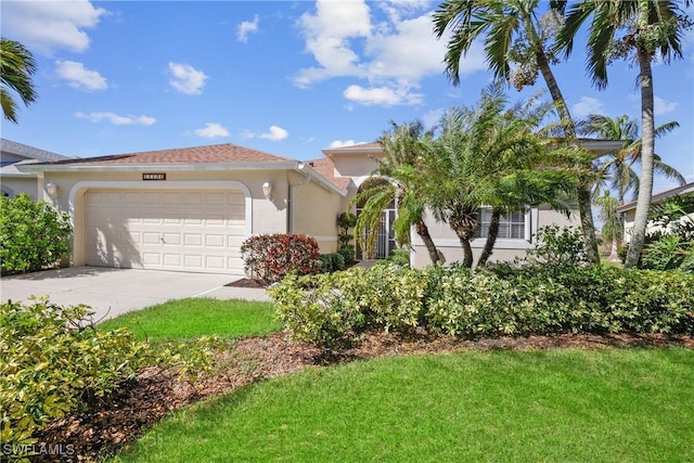 mediterranean / spanish-style home with a garage and a front lawn